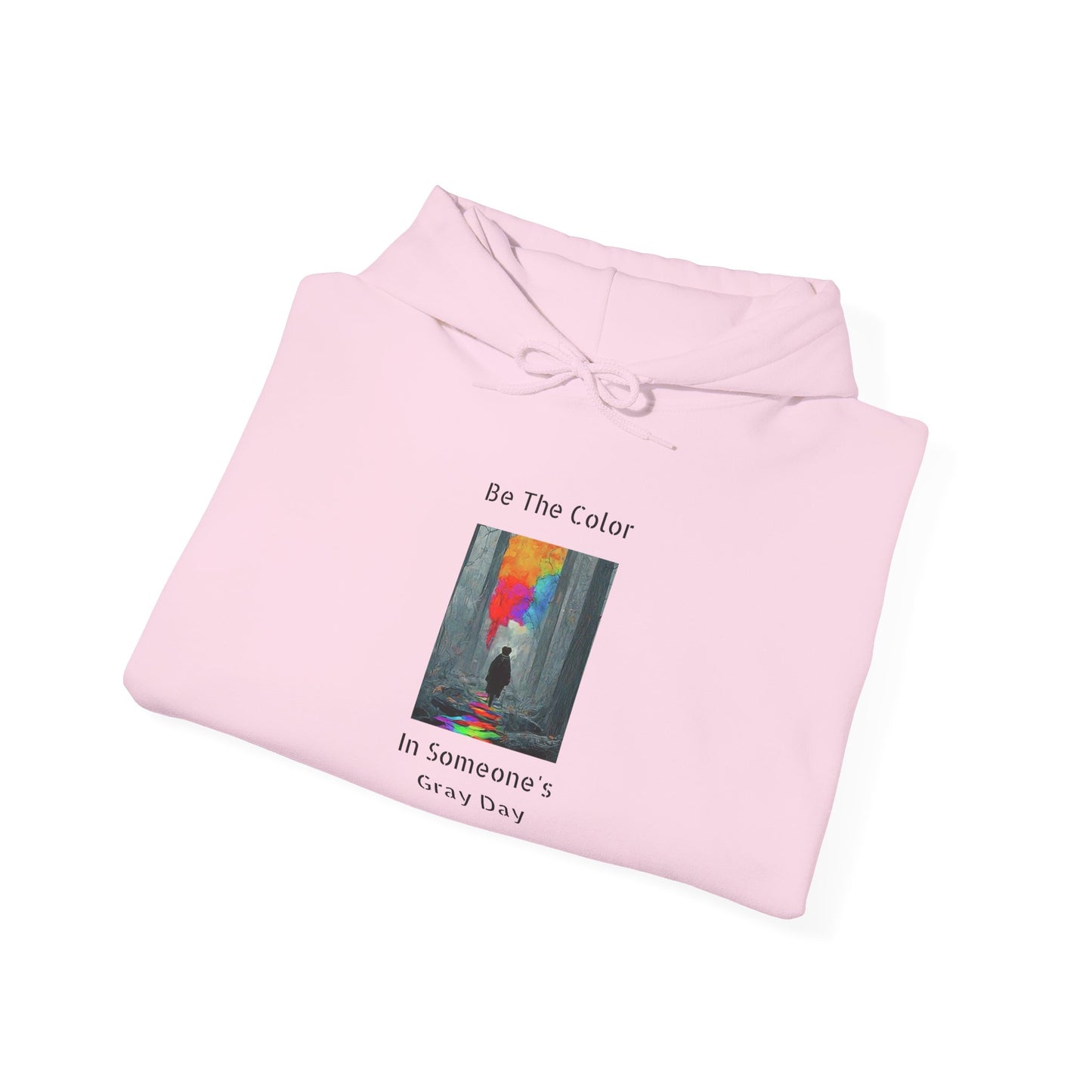 A graphic hoodie featuring the vibrant, uplifting text 'Be The Color in Someone's Gray Day' centered on the chest, paired with colorful design accents.