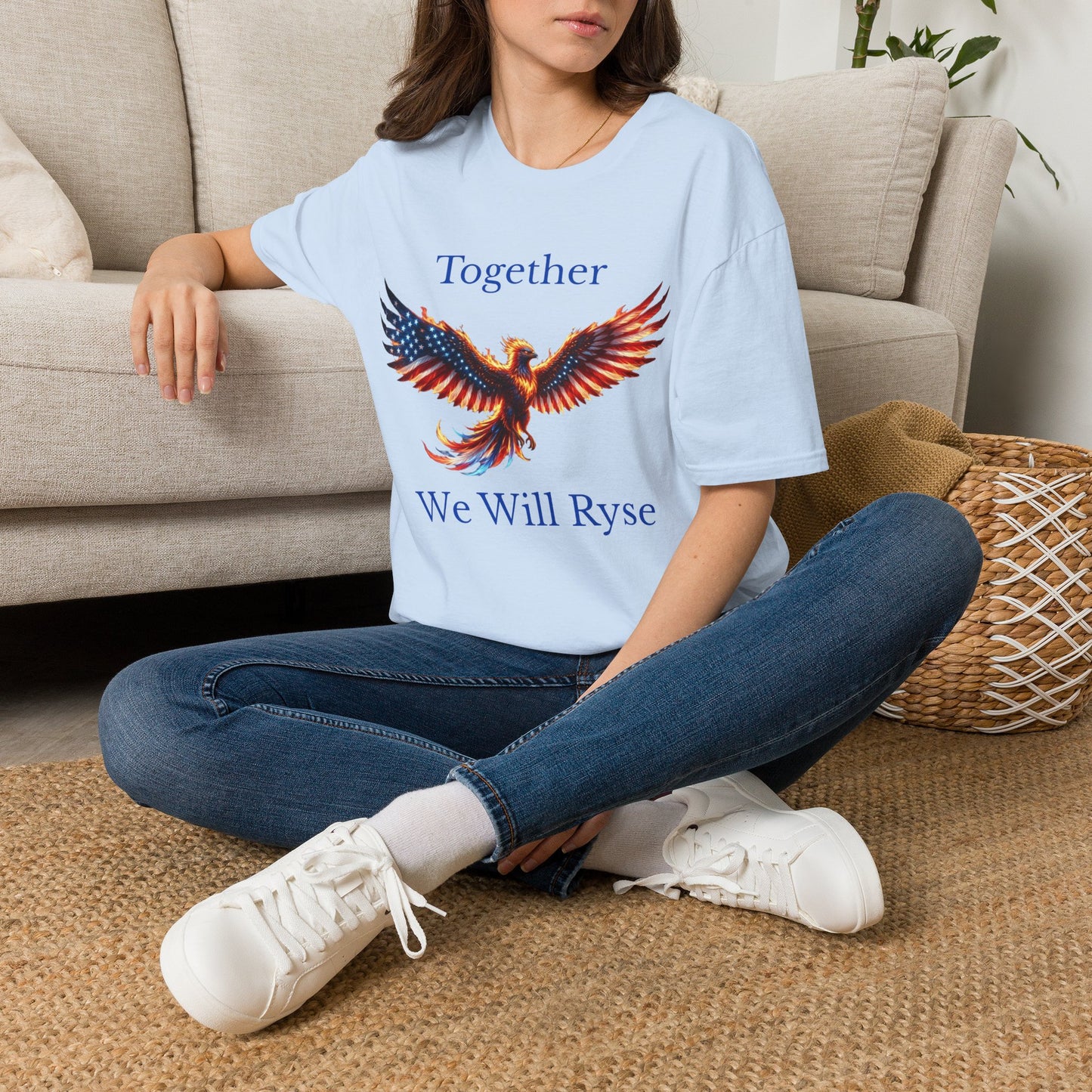 An Awareness Attire tee featuring Ryse the phoenix styled in a red, white, and blue American flag pattern alongside the inspiring slogan 'Together We Will Rise' in light blue