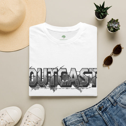 A folded white graphic T-shirt is arranged in a styled flat lay on a light beige surface, surrounded by a straw hat, white sneakers, blue jeans, sunglasses, and two small potted succulents. The shirt features a large distressed gray and black 'OUTCAST' graphic across the chest.