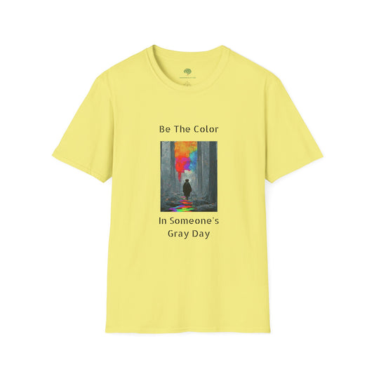 A graphic t-shirt featuring the vibrant, uplifting text 'Be The Color in Someone's Gray Day' centered on the chest, paired with colorful design accents.