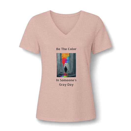 A graphic v neck featuring the vibrant, uplifting text 'Be The Color in Someone's Gray Day' centered on the chest, paired with colorful design accents in heather peach